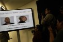 Photographers take pictures of a display with photos of Mario Ramirez Trevino, known as X-20, during a news conference at the interior ministry in Mexico City