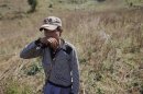 Local villager walks after assisting authorities to destroy a poppy field above the village of Tar-Pu in mountains of Shan State