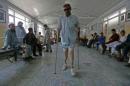 Mohammad Zaman walks with his prosthetic legs at the International Committee of the Red Cross (ICRC) orthopaedic rehabilitation center in Kabul