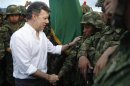 Colombia's President Juan Manuel Santos greets soldiers after an inauguration ceremony to launch three new active Army brigades, at Tolemaida Air Base