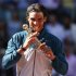 Nadal of Spain bites the Ion Tiriac's trophy as he poses after winning the Madrid Open final tennis match against Wawrinka of Switzerland in Madrid