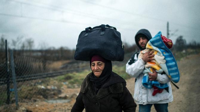 Migrants make their way across the Macedonia-Serbia border at Tabanovce on February 4, 2016