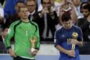 Germany's goalkeeper Manuel Neuer, recipient of the Golden Glove trophy, stands next to Argentina's Lionel Messi after he receive the Golden Ball trophy following Germany's 1-0 victory over Argentina after the World Cup final soccer match between Germany and Argentina at the Maracana Stadium in Rio de Janeiro, Brazil, Sunday, July 13, 2014. (AP Photo/Natacha Pisarenko)