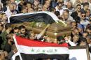Relatives of Iraq's former foreign minister Tareq Aziz and supporters of the Baath Party in Jordan carry Aziz's coffin during his funeral in the Jordanian city of Madaba on June 13, 2015