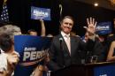 David Perdue waves to supporters after declaring victory in the Republican primary runoff for nomination to the U.S. Senate from Georgia, at his election-night party in Atlanta, Tuesday, July 22, 2014. Perdue defeated Rep. Jack Kingston. (AP Photo)
