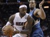 Miami Heat's James drives against Minnesota Timberwolves' Love in first half of NBA basketball game in Miami, Florida