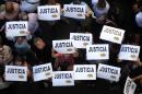 Citizens hold placards that read "Justice" during a rally in front of the headquarters of the AMIA, in Buenos Aires on January 21, 2015