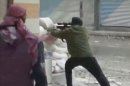 This image from amateur video AP obtained from Ugarit News has been authenticated based on its contents and other AP reporting and shows a rebel firing a weapon around a corner at Syrian government forces in Damascus, Syria Friday Dec. 7, 2012. Fighting around the Syrian capital has intensified in recent days as rebels press a battle they hope will lead to the collapse of President Bashar Assad's regime after 20 months of conflict. (AP Photo/Ugarit News via AP Video)