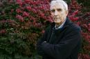 FILE - Writer Peter Matthiessen stands in the yard of his house in Sagaponack, N.Y. in this Oct. 28, 2004 file photo. Matthiessen, award-winning author of more than thirty books, world-renowned naturalist, explorer, Buddhist teacher, and political activist, died Saturday, April 5, 2014 after an illness of some months,according to his publisher Geoff Kloske of Riverhead Books. He was 86. (AP Photo/Ed Betz, File)