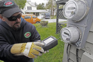 Mark Delbeck of Burlington Electric, checks the radio frequency of a newly-installed "smart" meter on Thursday, May 10, 2012, in Burlington, Vt. Vermont has become a hotbed in the debate over possible health effects and damage to privacy from a new generation of "smart" electric meters, wth lawmakers passing a measure to block utilities from charging customers for not having them. It's possible Vermont is the first state to not charge customers to "opt-out."(AP Photo/Toby Talbot)