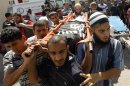 Palestinian carry the body of a militant Rmelat during his funeral in the southern Gaza Strip