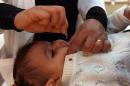 A Yemeni child receives a polio vaccination during a polio immunization campaign at a health center in Sanaa on December 16, 2013