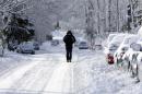 A pedestrian makes their way along a snow packed street in Indianapolis Monday, Jan. 6, 2014 as temperatures hovered around 10 below zero. More than 12 inches of snow fell on Sunday. (AP Photo/Michael Conroy)