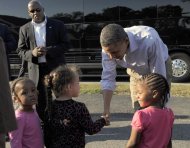 President Barack Obama stops to visit with people on the side of the road in Brodnax, Va, Tuesday, Oct. 18, 2011. Obama is on a three-day bus tour promoting the American Jobs Act. (AP Photo/Susan Walsh)
