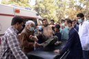 Residents and medics transport a Syrian Army soldier, wounded in what they said was a chemical weapon attack near Aleppo, to a hospital