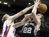 Detroit Pistons forward Kyle Singler, left, knocks a rebound away from San Antonio Spurs center Tiago Splitter (22) in the second half of an NBA basketball game Friday, Feb. 8, 2013, in Auburn Hills, Mich. The Pistons defeated the Spurs 119-109. (AP Photo/Duane Burleson)