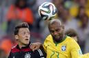 Germany's Mesut Ozil, left, and Brazil's Maicon go for a header during the World Cup semifinal soccer match between Brazil and Germany at the Mineirao Stadium in Belo Horizonte, Brazil, Tuesday, July 8, 2014. (AP Photo/Frank Augstein)