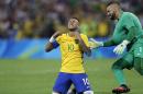 Brazil's Neymar cries as he kneels down to celebrate with teammate goalkeeper Weverton after scoring the decisive penalty kick during the final match of the men's Olympic football tournament between Brazil and Germany at the Maracana stadium in Rio de Janeiro, Brazil, Saturday Aug. 20, 2016. Brazil won the gold medal on a penalty shootout. (AP Photo/Andre Penner)