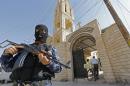 An Iraqi security officer, stands guard outside the Church of the Virgin Mary in the northern town of Bartala, east of the northern city of Mosul on June 15, 2012