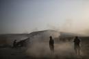 Kurdish Peshmerga soldiers fire artillery at Islamic State positions in Bashiqa, east of Mosul, Iraq, Monday, Nov. 7, 2016. Iraqi Kurdish fighters exchanged heavy fire with IS militants early on Monday as they advanced from two directions on a town held by the Islamic State group east of the city of Mosul. (AP Photo/Felipe Dana)