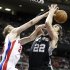 Detroit Pistons forward Kyle Singler, left, knocks a rebound away from San Antonio Spurs center Tiago Splitter (22) in the second half of an NBA basketball game Friday, Feb. 8, 2013, in Auburn Hills, Mich. The Pistons defeated the Spurs 119-109. (AP Photo/Duane Burleson)