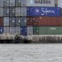 In this Tuesday, Jan. 8, 2013 photo, shipping containers are stacked at the Port of Miami. U.S. wholesalers boosted their stockpiles in January by the largest amount in 13 months, even though their sales dropped sharply. (AP Photo/Wilfredo Lee)