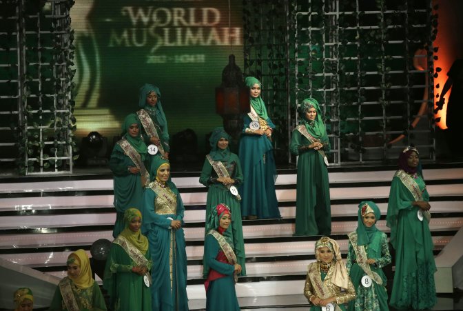 Wednesday, Sept. 18, 2013 photo, contestants line up on the stage during the 3rd Annual Award of World Muslimah, a competition billed as the Islamic alternative to Miss World pageant, in Jakarta, Indonesia. Beauty queens and backstage drama may seem inevitable, but at this year's Miss World competition, something more serious than hair-pulling and name-calling has come from host country Indonesia: Muslim hardliners have threatened to hijack the competition despite major concessions from the government and organizers. (AP Photo/Dita Alangkara)