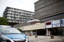 A police car is parked in front of the university clinic in Steglitz, a southwestern district of Berlin
