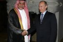 Prince Bandar bin Sultan, Secretary-General of Saudi Arabia's National Security Council shakes hands with Russia's Prime Minister Vladimir Putin as they meet in Moscow