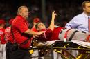 Garrett Richards of the Los Angeles Angels is carried off the field on a stretcher after suffering a leg injury against the Boston Red Sox on August 20, 2014 at Fenway Park in Boston, Massachusetts