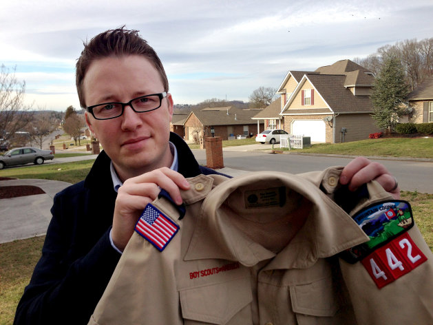 FILE - In this Monday, Feb. 4, 2013 photo provided by the family, Wes Comer holds the Boy Scout uniform of his son, Isaiah, outside their home in Knoxville, Tenn. Comer, whose family attends an Apostolic Pentecostal church which considers homosexuality sinful, had been wrestling with whether to pull his eldest son out of the Scouts if the no-gays policy was abandoned. "To be honest, I'm torn at this point," Comer said in an e-mail Friday, May 24, 2013. "I'm not sure exactly what our decision will be." "If I place this situation in the context of my religious beliefs, I'm forced to ask myself, 'Would I turn a homosexual child away from Sunday School? From a church function? Would I forbid my children to be friends with a gay child?' I can't imagine a situation where I would answer 'yes' to any of those questions. So how can I in this one?" he wrote. (AP Photo/Brooke Comer)