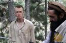FILE - This file image provided by IntelCenter on Dec. 8, 2010, shows a frame grab from a video released by the Taliban containing footage of a man believed to be Bowe Bergdahl, left. Saturday, May 31, 2014, U.S. officials say Bergdahl, the only American soldier held prisoner in Afghanistan has been freed and is in U.S. custody. The officials say his release was part of a negotiation that includes the release of five Afghan detainees held in the U.S. prison at Guantanamo Bay, Cuba. (AP Photo/IntelCenter, File) MANDATORY CREDIT: INTELCENTER; NO SALES; EDS NOTE: "INTELCENTER" AT LEFT TOP CORNER ADDED BY SOURCE