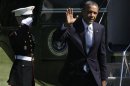 President Barack Obama waves as he walks on the South Lawn