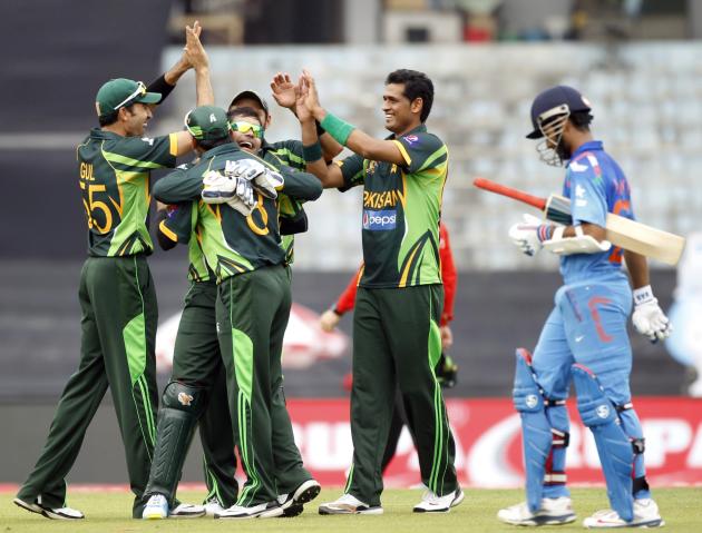 India&#39;s Rahane leaves the field as Pakistan&#39;s fielders celebrate his dismissal during their ODI cricket match in Asia Cup 2014 in Dhaka.