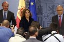 Spanish Treasury Minister Montoro, Economy Minister de Guindos and Deputy PM de Santamaria stand at start of news conference in Madrid