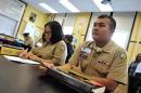 Miguel Martinez (R) sits in a chemistry class on October 22, 2013 at Rickover Naval Academy, one of seven public high schools in Chicago, Illinois which have received a two million USD grant from the US Navy