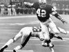 FILE - In this Sept. 30, 1979, file photo, New Orleans Saints running back Chuck Muncie (42) breaks a tackle by New York Giants safety Beasley Reece and heads for the end zone to score a touchdown during an NFL football game at the Superdome in New Orleans. The Saints announced Tuesday, May 14, 2013, that  Muncie, a Pro Bowl running back with both the Saints and San Diego Chargers, has died. He was 60.  (AP Photo/File