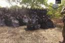 In this photo taken from video by Nigeria's Boko Haram terrorist network, Monday May 12, 2014 shows the alleged missing girls abducted from the northeastern town of Chibok. The new video purports to show dozens of abducted schoolgirls, covered in jihab and praying in Arabic. It is the first public sight of the girls since more than 300 were kidnapped from a northeastern school the night of April 14 exactly four weeks ago. (AP Photo)