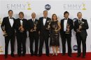 Alex Gansa and fellow writers pose with their award for outstanding writing for a drama series for "Homeland," backstage at the 64th Primetime Emmy Awards in Los Angeles