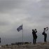 A Greek flag flutters at the Acropolis hill in Athens