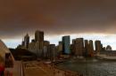 Smoke and ash from wildfires burning across the state of New South Wales blankets the Sydney city skyline on October 17, 2013