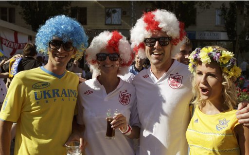 England and Ukraine soccer fans pose for a picture as they party in the centre of Donetsk