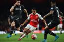 Arsenal's striker Alexis Sanchez (C) takes on Liverpool's midfielder James Milner (R) and defender Nathaniel Clyne during the English Premier League football match on August 24, 2015