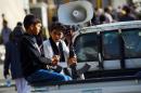 Yemeni boys sit in a pick-up truck during a demonstration by supporters of the Shiite Huthi movement in the capital Sanaa on April 22, 2015, against the Saudi-led military "Decisive Storm" air campaign