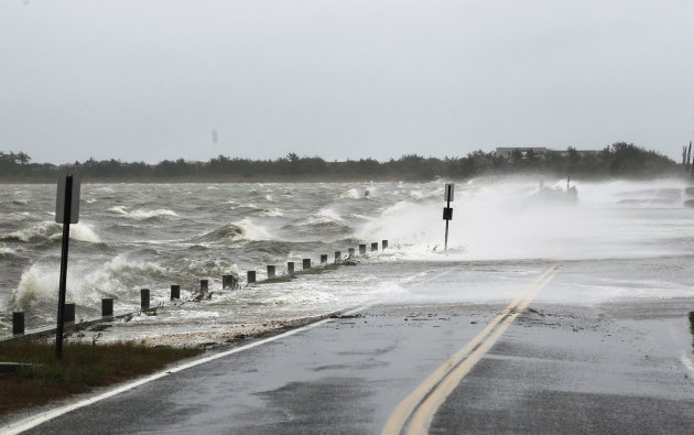 Waves crest over a road by winds caused by Hurricane Sandy in Southampton, New York