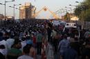 Supporters of Iraqi cleric Moqtada al-Sadr cross a bridge as they leave Baghdad's fortified "Green Zone" on May 20, 2016