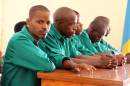 Joel Mutabazi (L) sits with his co-accused during his trial on January 28, 2014 in Kigali, Rwanda