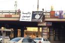 In this still image posted on a militant Twitter account on Thursday, June 12, 2014, which has been authenticated based on its contents and other AP reporting, a banner bearing a black flag used by the al-Qaida inspired lslamic State of Iraq and the Levant (ISIL) hangs from an overpass in Mosul, Iraq. Iraqi officials say al-Qaida-inspired militants who this week seized much of the country's Sunni heartland have pushed into an ethnically mixed province northeast of Baghdad, capturing two towns there. Arabic on the banner reads, "Ninevah State welcomes you. God is great and thanks to God. "(AP Photo/militant source via Twitter)