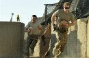 Britain's Prince Harry races out from the VHR tent to scramble his Apache helicopter at Camp Bastion, southern Afghanistan