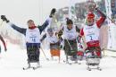 Mariann Marthinsen, right, of Norway, celebrates her gold medal as Tatyana Mcfadden, left, of the United States, reacts to her second-place finish in the finals of the women's cross country 1km sprint, sitting event at the 2014 Winter Paralympic, Wednesday, March 12, 2014, in Krasnaya Polyana, Russia. (AP Photo/Dmitry Lovetsky)